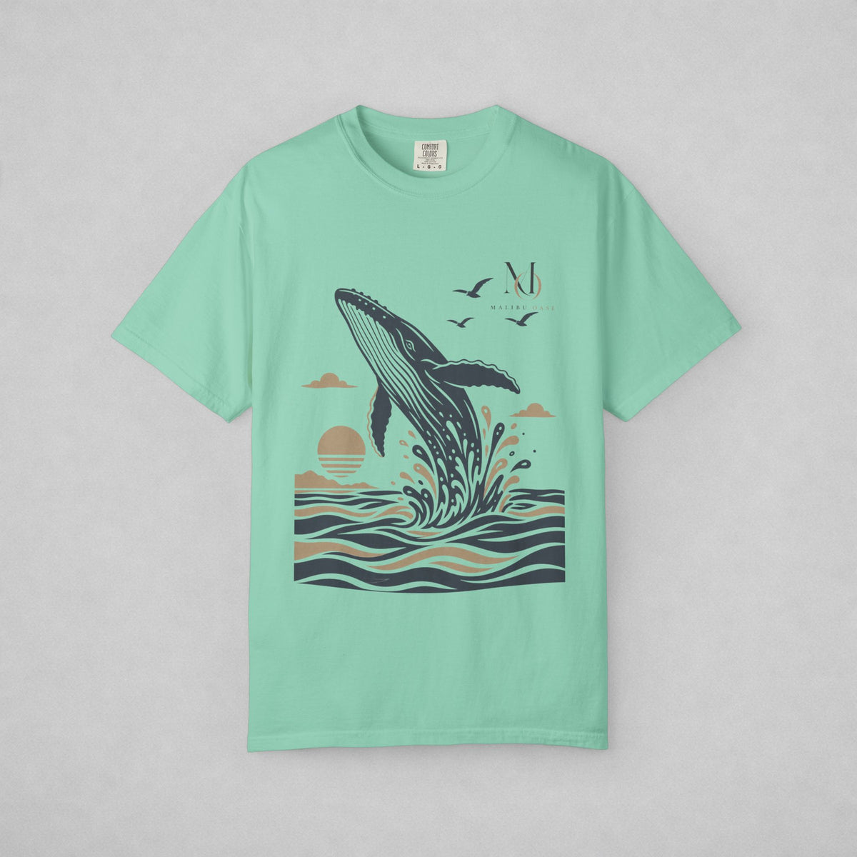 Island Reef. Short-sleeve crewneck t-shirt with a graphic print of a whale jumping out of the water, birds, and a sun, displayed on a neutral gray background.