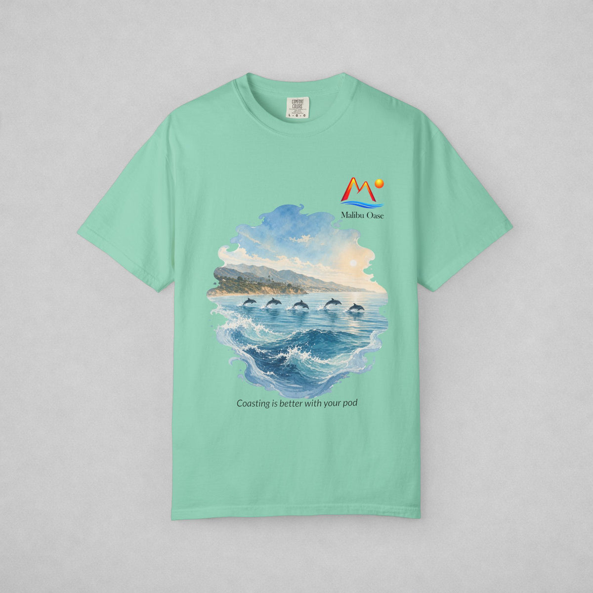 Island Reef.  Short-sleeve crewneck t-shirt with a watercolor-style graphic of dolphins in the blue ocean, with the text 'Coasting is better with your pod'.