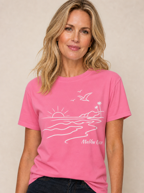 Woman wearing Crunchberry colored shirt with the text "Malibu Oase."