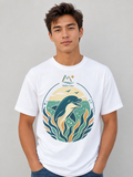 A man wearing a white crewneck t-shirt with a colorful graphic of a dolphin in an ocean scene, labeled 'Malibu Oase'.