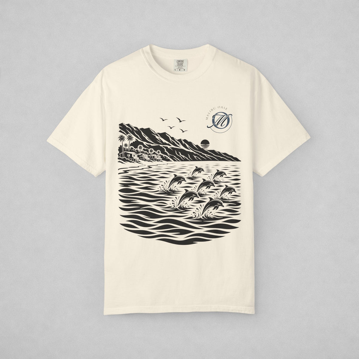 An off-white short-sleeve t-shirt with a black graphic print of dolphins jumping in water, mountains, and birds, displayed flat against a neutral gray background.