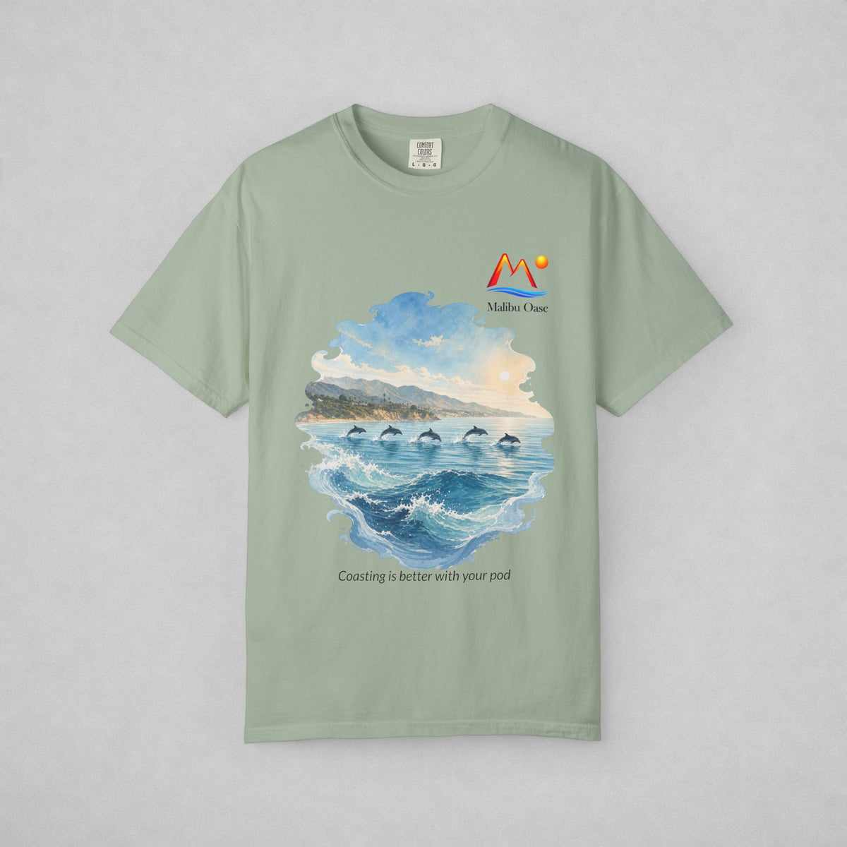 A Bay short-sleeve crewneck t-shirt with a watercolor-style graphic of dolphins in the blue ocean, with the text 'Coasting is better with your pod'.