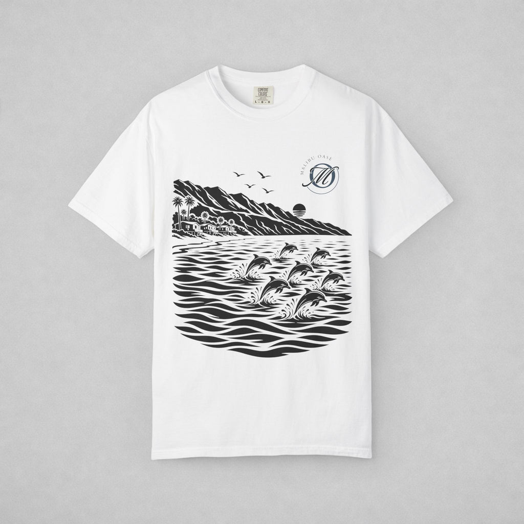 A white short-sleeve crewneck t-shirt with a black graphic print of dolphins jumping in water, mountains, birds, and a circular logo on the left chest, displayed flat against a neutral gray background.