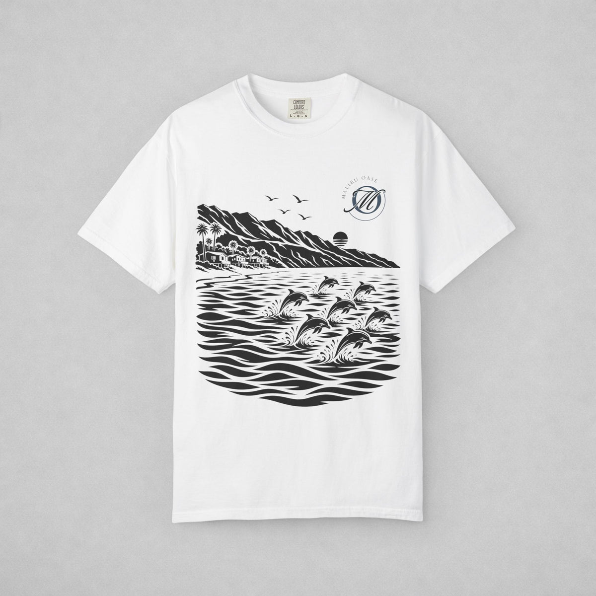 A white short-sleeve crewneck t-shirt with a black graphic print of dolphins jumping in water, mountains, birds, and a circular logo on the left chest, displayed flat against a neutral gray background.