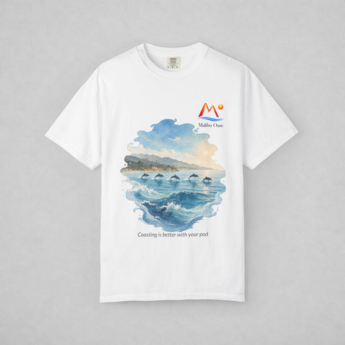 A white short-sleeve crewneck t-shirt with a watercolor-style graphic of dolphins in the blue ocean, with the text 'Coasting is better with your pod'.