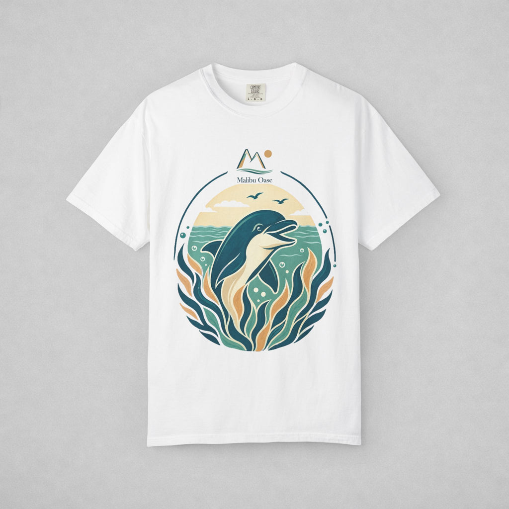 A white short-sleeve crewneck t-shirt with a circular graphic print of a dolphin jumping from teal water with stylized waves and the text 'Maibu Oase', displayed flat against a neutral gray background.